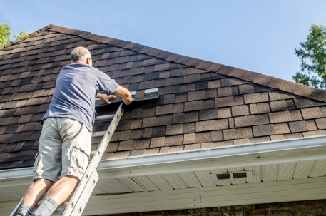 an old man on a ladder checking roof shingles