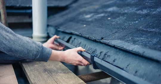 Hands of Homeowner Fixing Drain